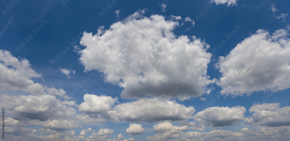 blue sky with dense cumulus clouds, natural sky background
