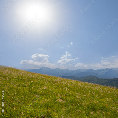 green mountain valley under a sparkle sun, summer travel scene