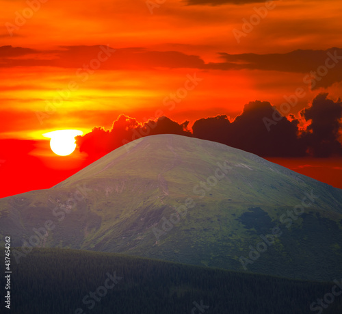 green mount top on red sunset background