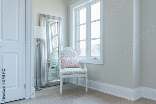 Fototapeta Naklejka Na Ścianę i Meble -  Interior of a Room with a Chair by a Window
