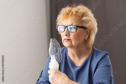 close-up of an elderly woman with an inhaler