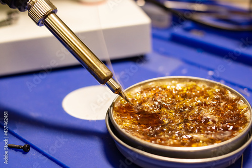 Fotografie Hot soldering iron and yellow rosin closeup