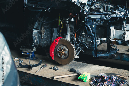 car under repair brake disc and caliper photo