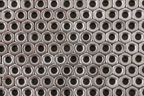 Stainless steel nuts background macro photo.
