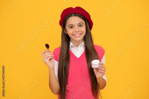 happy teen girl in french beret apply blush with powder bwush, skincare © Olena