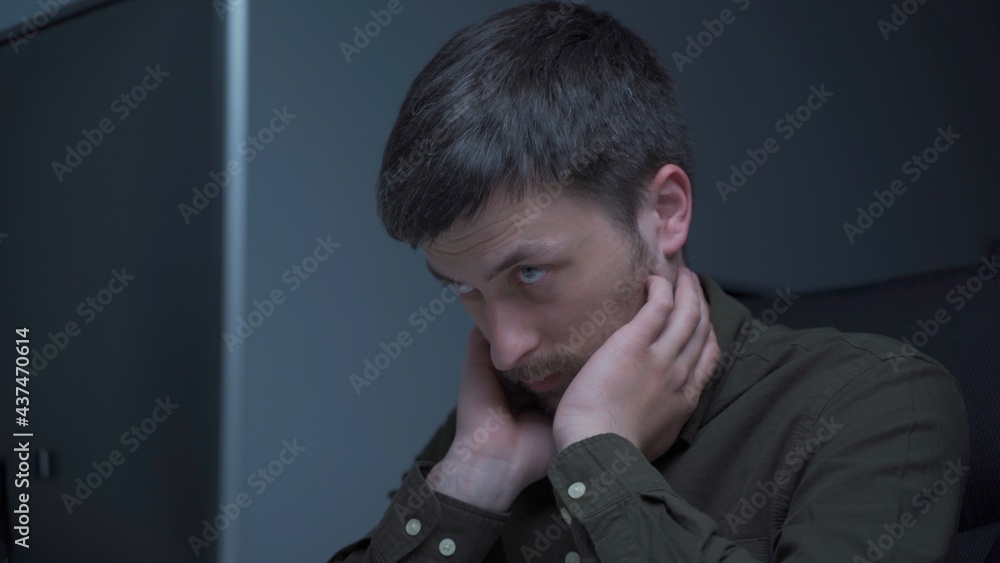 Young caucasian man working overtime at computer and eye fatigue from monitor in home office. Male having stressful time working on PC. Exhausted programmer stressful work, stress at workplace Young caucasian man working overtime at computer and eye fatigue from monitor in home office. Male having stressful time working on PC. Exhausted programmer stressful work, stress at workplace