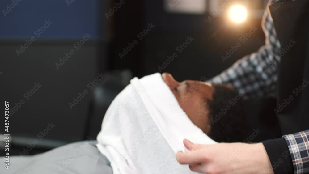 Barber shaving his client with classical razor Barber shaving his client with classical razor