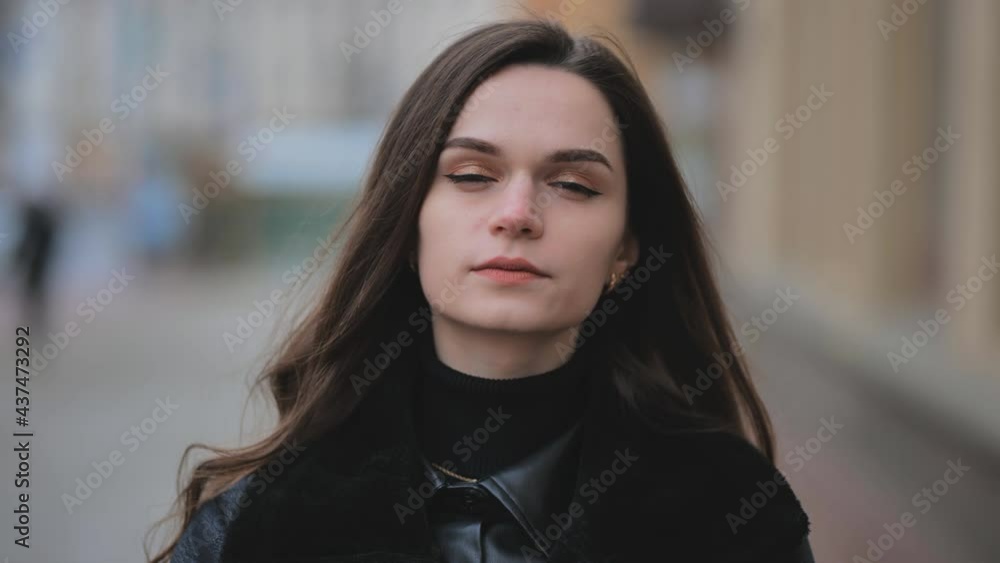 Portrait of a young girl on a city street in early spring. Portrait of a young girl on a city street in early spring.