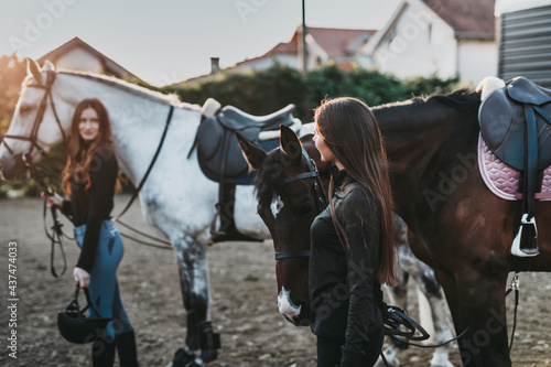 Beautiful young women enjoying with their horses..