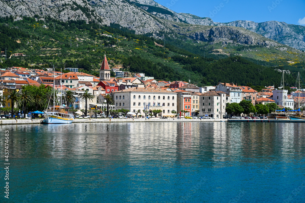 Makarska, Croatia. Popular tourist destination in Dalmatia. Mountains, buildings, riva and Adriatic sea. Cityscape. 