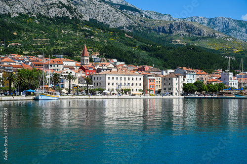 Makarska, Croatia. Popular tourist destination in Dalmatia. Mountains, buildings, riva and Adriatic sea. Cityscape.  © Ajdin Kamber