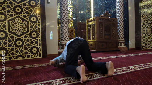 A Muslim man is prostrating in prayer
