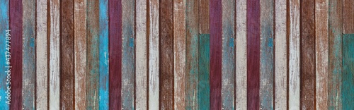 Panorama of Old wooden house wall with many colors in vintage style texture and background seamless © torsakarin