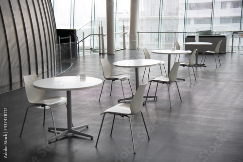 The chair and table is arranged in new normal style for social distancing which one of the Coivid-19 countermeasure and prevention. This layout is for people gathering and meeting with keep distance.