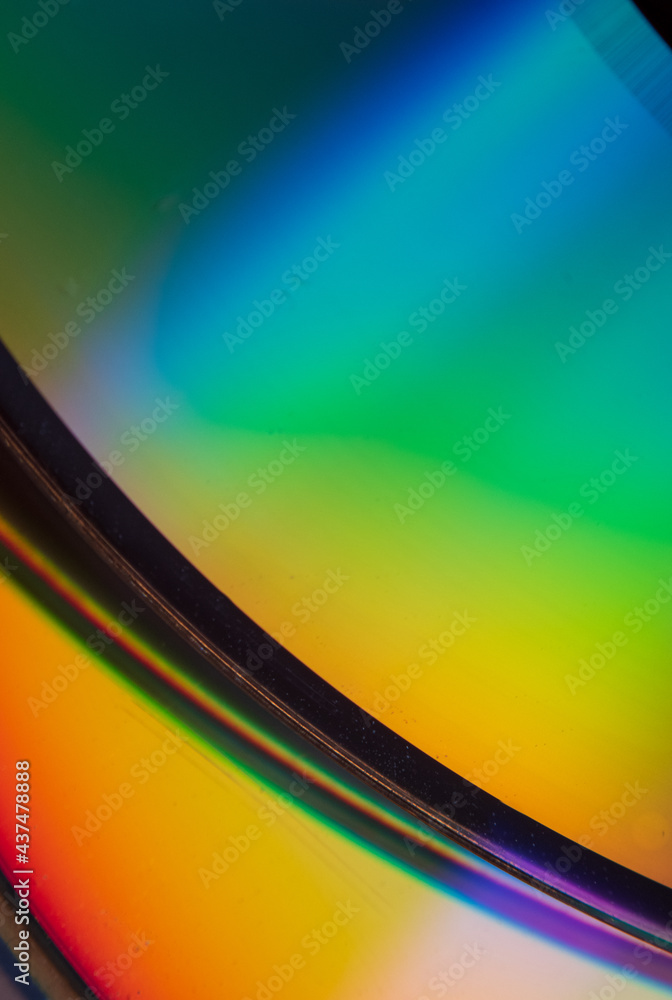 Abstract photo of the reflection of the bottom of a CD displaying a ...