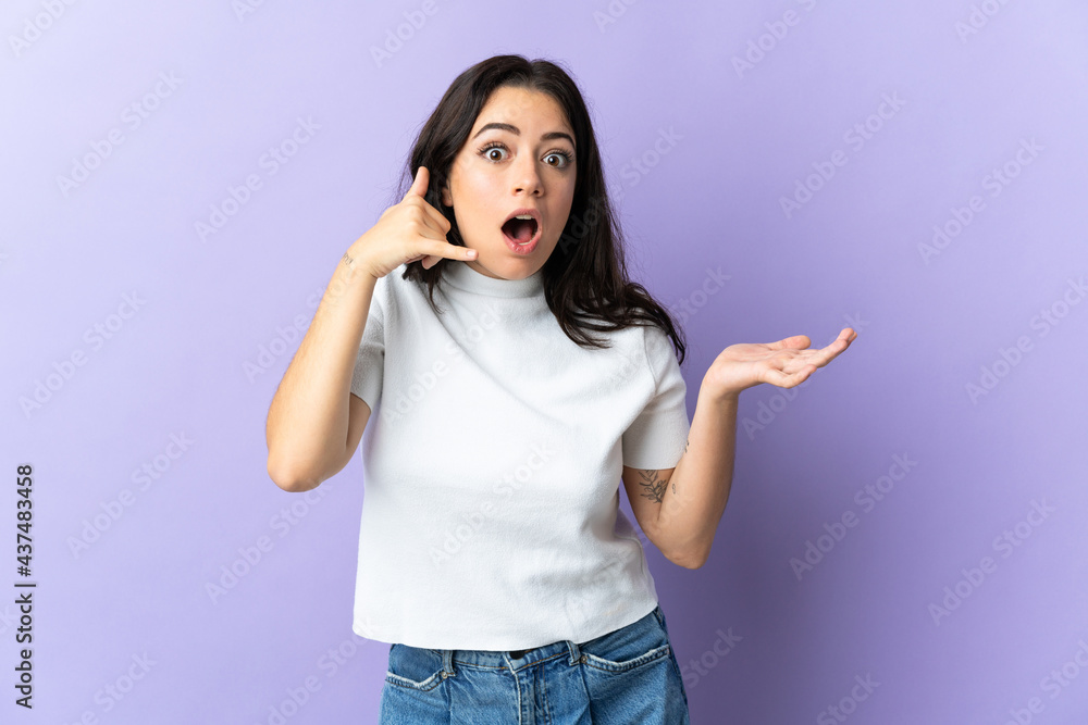 Young caucasian woman isolated on purple background making phone gesture and doubting Young caucasian woman isolated on purple background making phone gesture and doubting