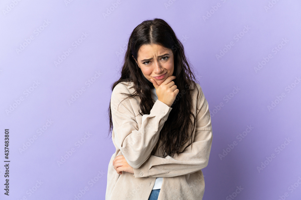 Young caucasian woman isolated on purple background having doubts Young caucasian woman isolated on purple background having doubts
