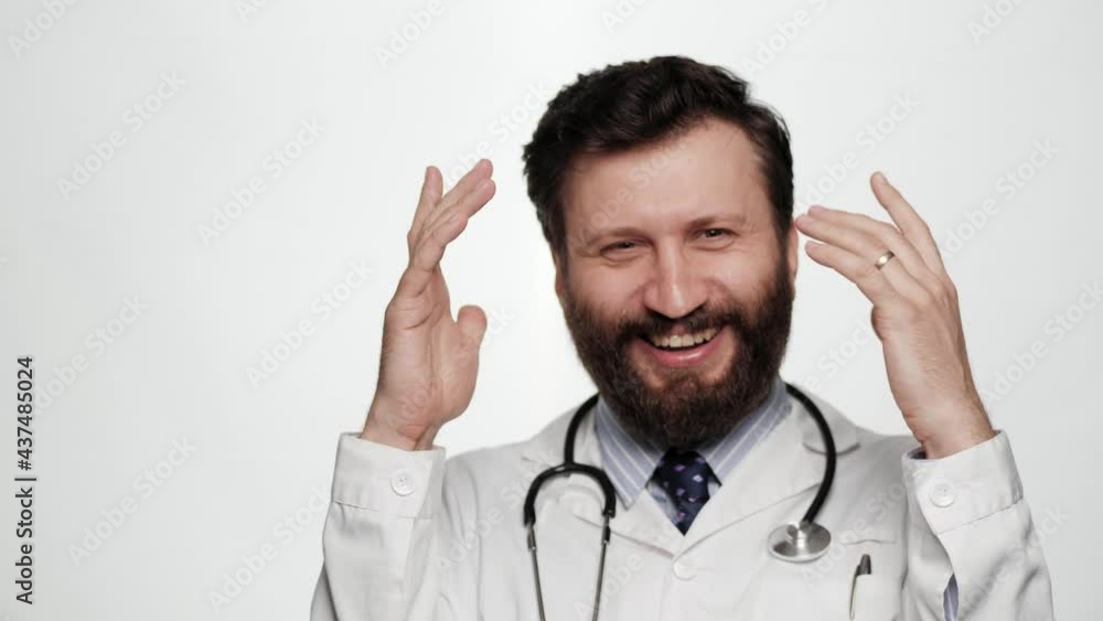 Funny crazy doctor is scared, terrified. Frightened man doctor on white background looking at camera throws his hands up and screams, he is very scared and just terrified Funny crazy doctor is scared, terrified. Frightened man doctor on white background looking at camera throws his hands up and screams, he is very scared and just terrified