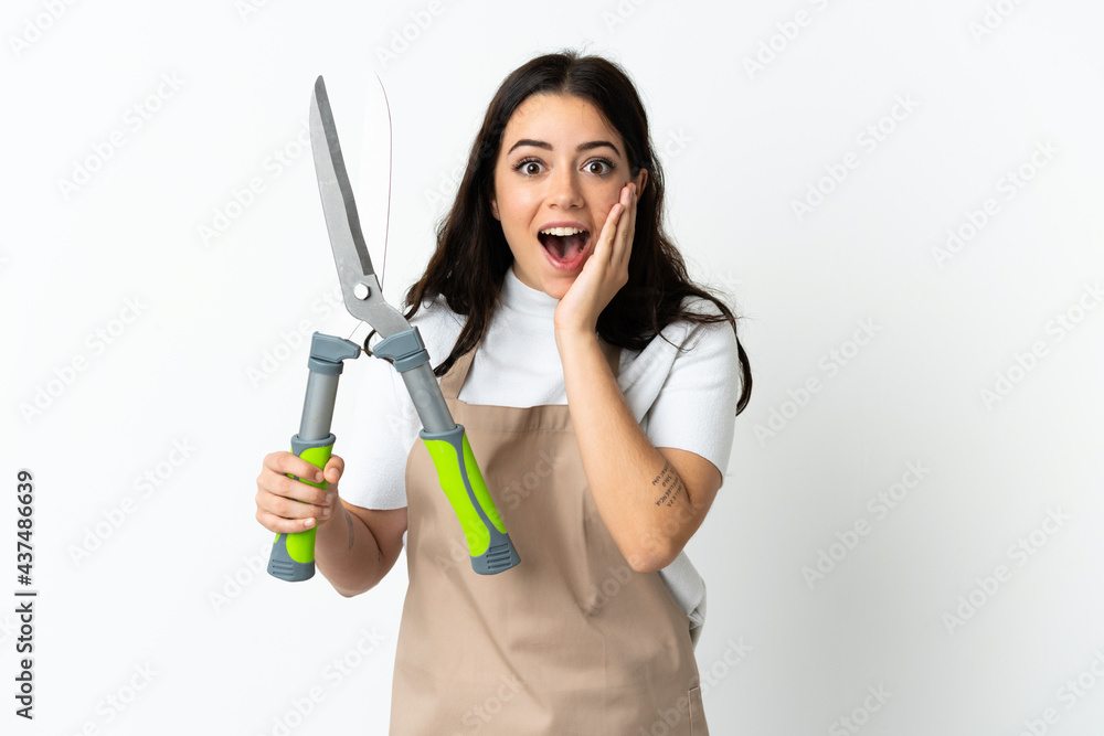 Young caucasian woman holding a plant isolated on white background with surprise and shocked facial expression Young caucasian woman holding a plant isolated on white background with surprise and shocked facial expression