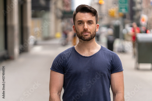 Young caucasian man on city street serious face portrait