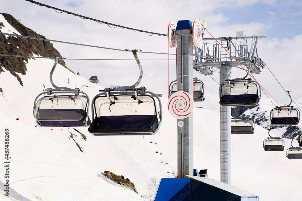 Open air ski lift going to the top of the mountain for alpine skiing. Open air ski lift going to the top of the mountain for alpine skiing.