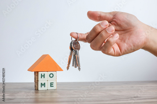Fotografi A model of a house made from white cubes with lettering HOME