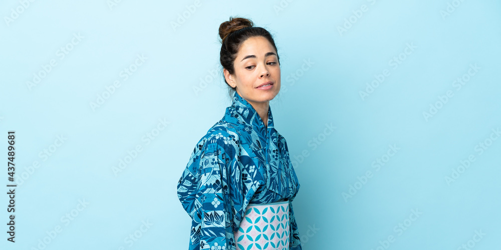 Woman wearing kimono over isolated background . Portrait Woman wearing kimono over isolated background . Portrait