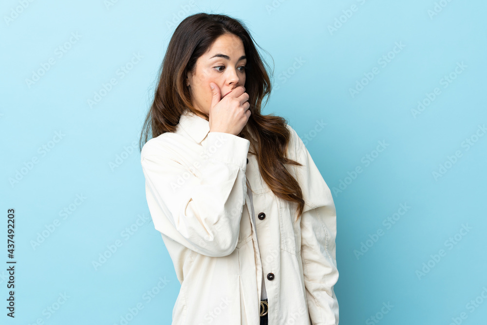 Woman over isolated background doing surprise gesture while looking to the side Woman over isolated background doing surprise gesture while looking to the side