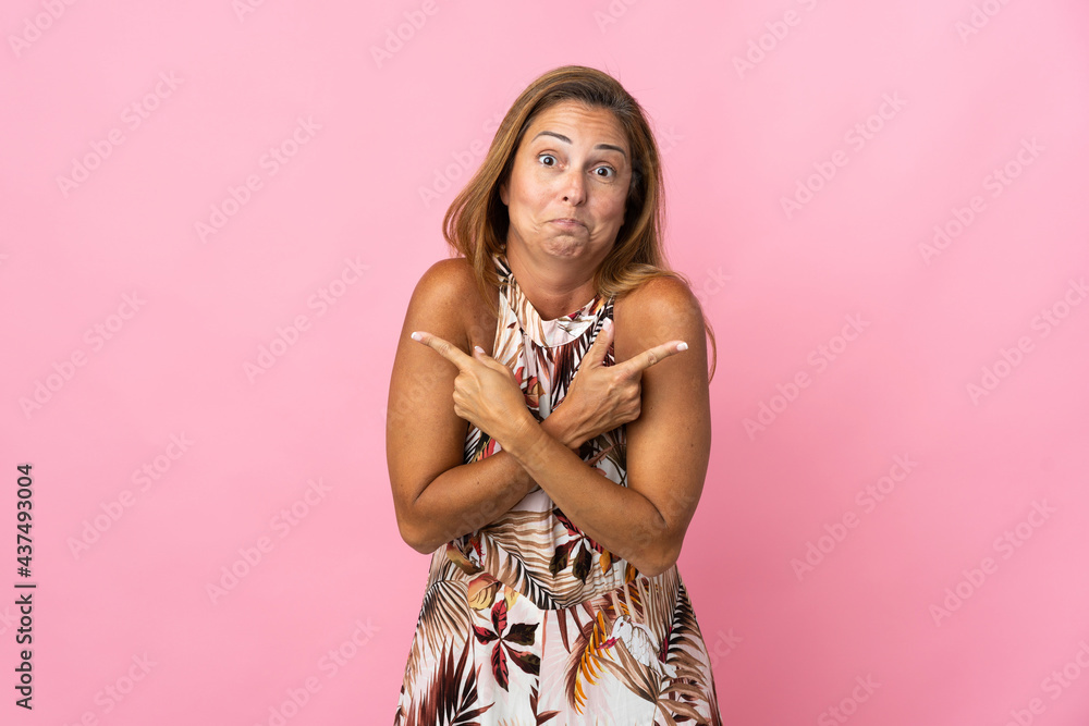 Middle age brazilian woman over isolated background pointing to the laterals having doubts Middle age brazilian woman over isolated background pointing to the laterals having doubts