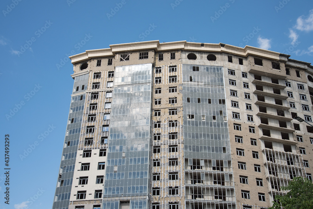 High unfinished building. Home or office center. Blue sky