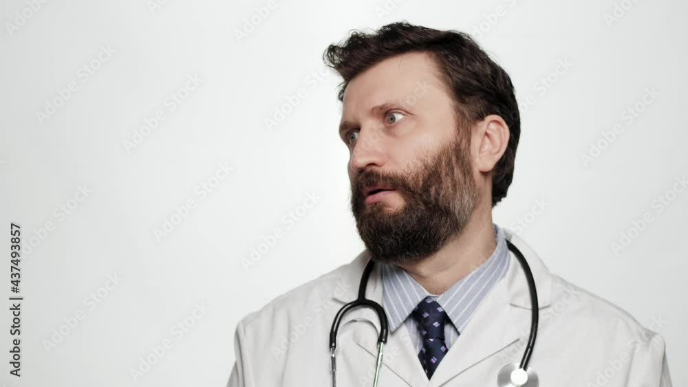 Skeptic doctor, sarcasm emotion. Dissatisfied man doctor on white background looking at camera expressing skeptical attitude and discontent with his look Skeptic doctor, sarcasm emotion. Dissatisfied man doctor on white background looking at camera expressing skeptical attitude and discontent with his look