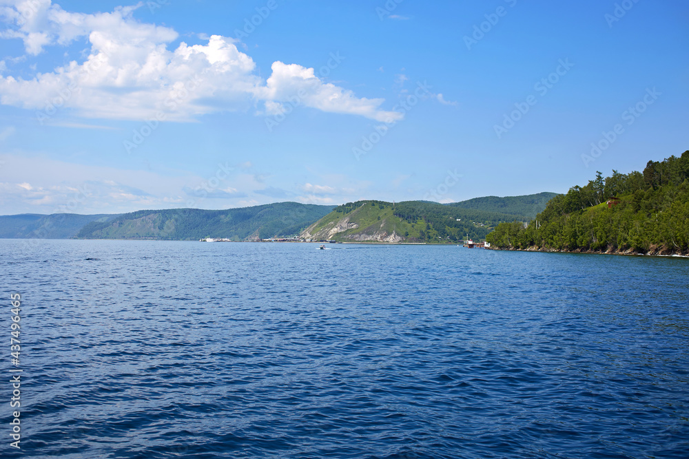 Lake Baikal on a summer day. Listvyanka village. View of the source of the Angara River. Lake Baikal on a summer day. Listvyanka village. View of the source of the Angara River.