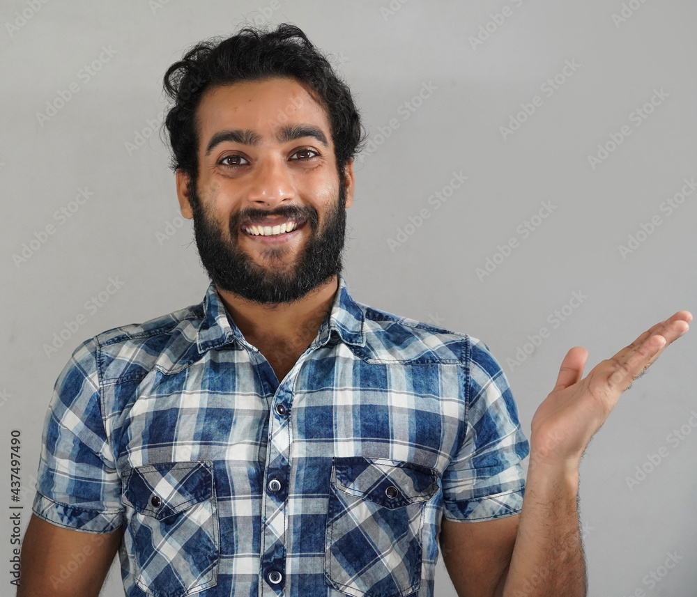 young man showing something in right side using hand young man showing something in right side using hand