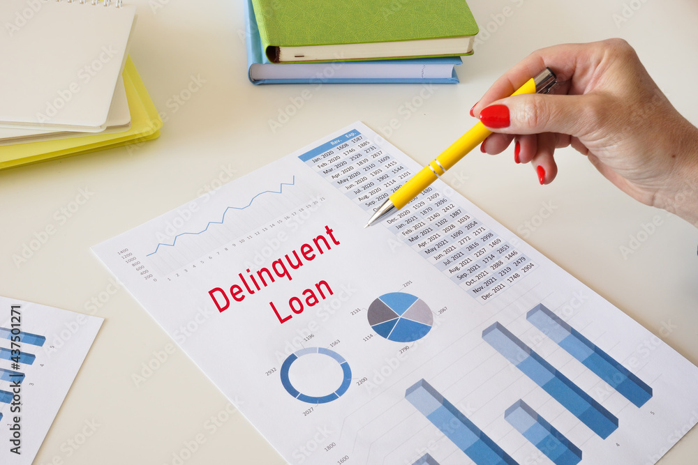 Delinquent Loan sign on the sheet. Delinquent Loan sign on the sheet.