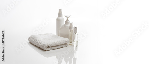 white spa towel and jars with bottles of body care