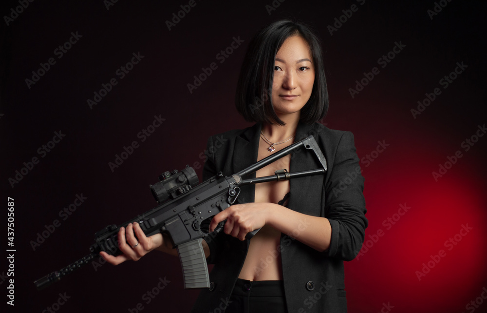 asian woman in a jacket with an automatic rifle in her hands mafia fighter asian woman in a jacket with an automatic rifle in her hands mafia fighter