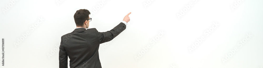 The man gesturing on the background of the white wall background The man gesturing on the background of the white wall background