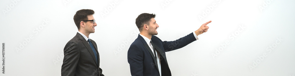 The two businessmen walking with a bag on the white wall background The two businessmen walking with a bag on the white wall background