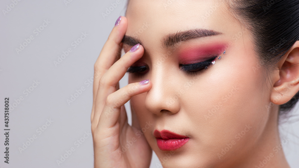 Asian female closeup colorful eyeshadow with extreme long false eyelashes. Eyelash Extensions. Makeup, Cosmetics, Beautiful cosmetics makeup concept. Asian female closeup colorful eyeshadow with extreme long false eyelashes. Eyelash Extensions. Makeup, Cosmetics, Beautiful cosmetics makeup concept.