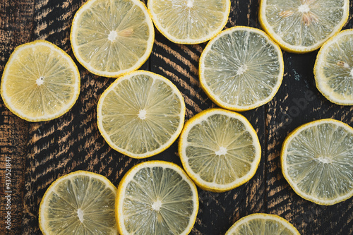  lemons with leaves on wooden background