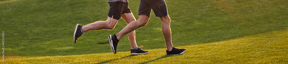 The old and young sportsmen running in the green park The old and young sportsmen running in the green park