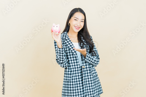 Portrait beautiful young asian woman with piggy bank