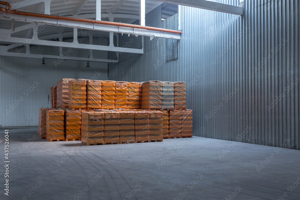 The storage and carriage at industrial food industry facility. A glass clear bottles for alcoholic or soft drinks beverages and canning jars stacked on pallets for forklift. The storage and carriage at industrial food industry facility. A glass clear bottles for alcoholic or soft drinks beverages and canning jars stacked on pallets for forklift.