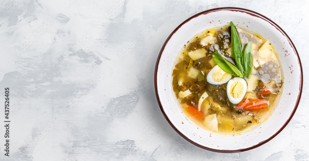 Fresh dietary soup orrel and eggs, potatoes on a white background. called green borsch for weight loss, Long banner format. top view Fresh dietary soup orrel and eggs, potatoes on a white background. called green borsch for weight loss, Long banner format. top view