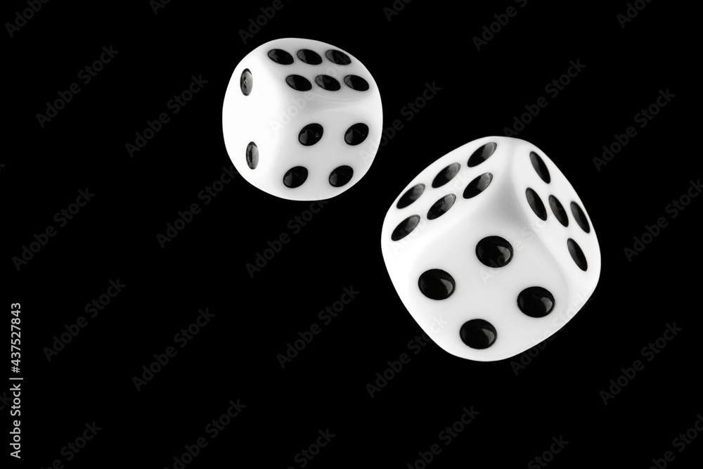 the dice are black with white dots, isolated on a black background for clipping the dice are black with white dots, isolated on a black background for clipping