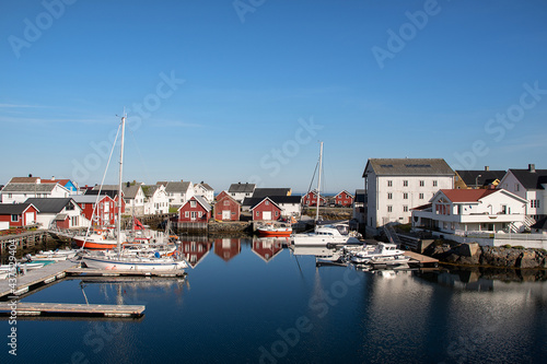 Boats in the harbor, reflected in calm sea. Veiholmen, Smøla, Norway.