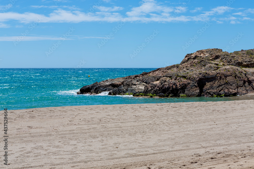 End of Bolnuevo beach, Murcia, Spain. with fine sand, rocky area and turquoise waters