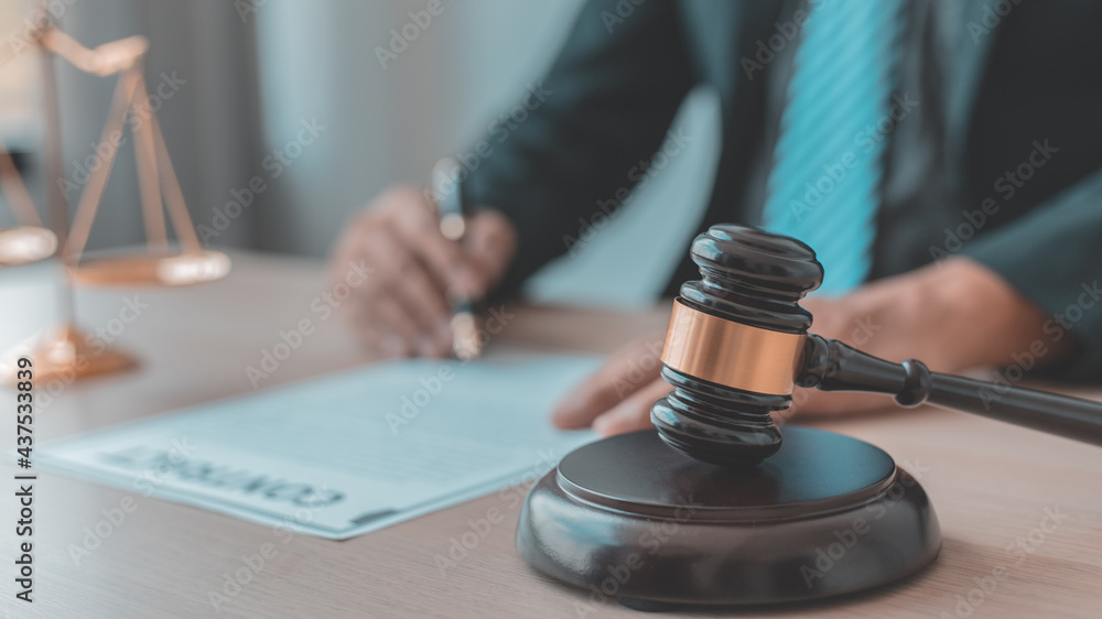 Lawyers or judges sign documents in accordance with legal and fair terms of agreement, Legal Ethics and Integrity, scales of justice, law hammer, Litigation and legal services. Lawyers or judges sign documents in accordance with legal and fair terms of agreement, Legal Ethics and Integrity, scales of justice, law hammer, Litigation and legal services.
