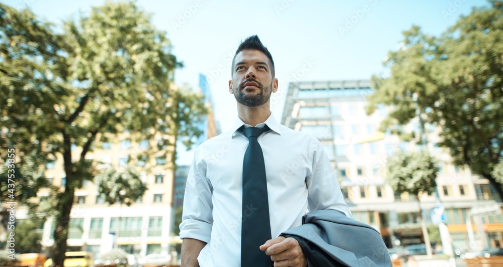 Portrait of dedicated businessman outdoors on street. Portrait of dedicated businessman outdoors on street.