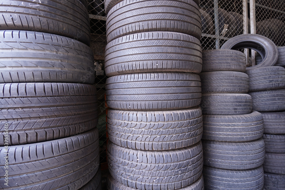The group of old used car rubber tires stacked The group of old used car rubber tires stacked